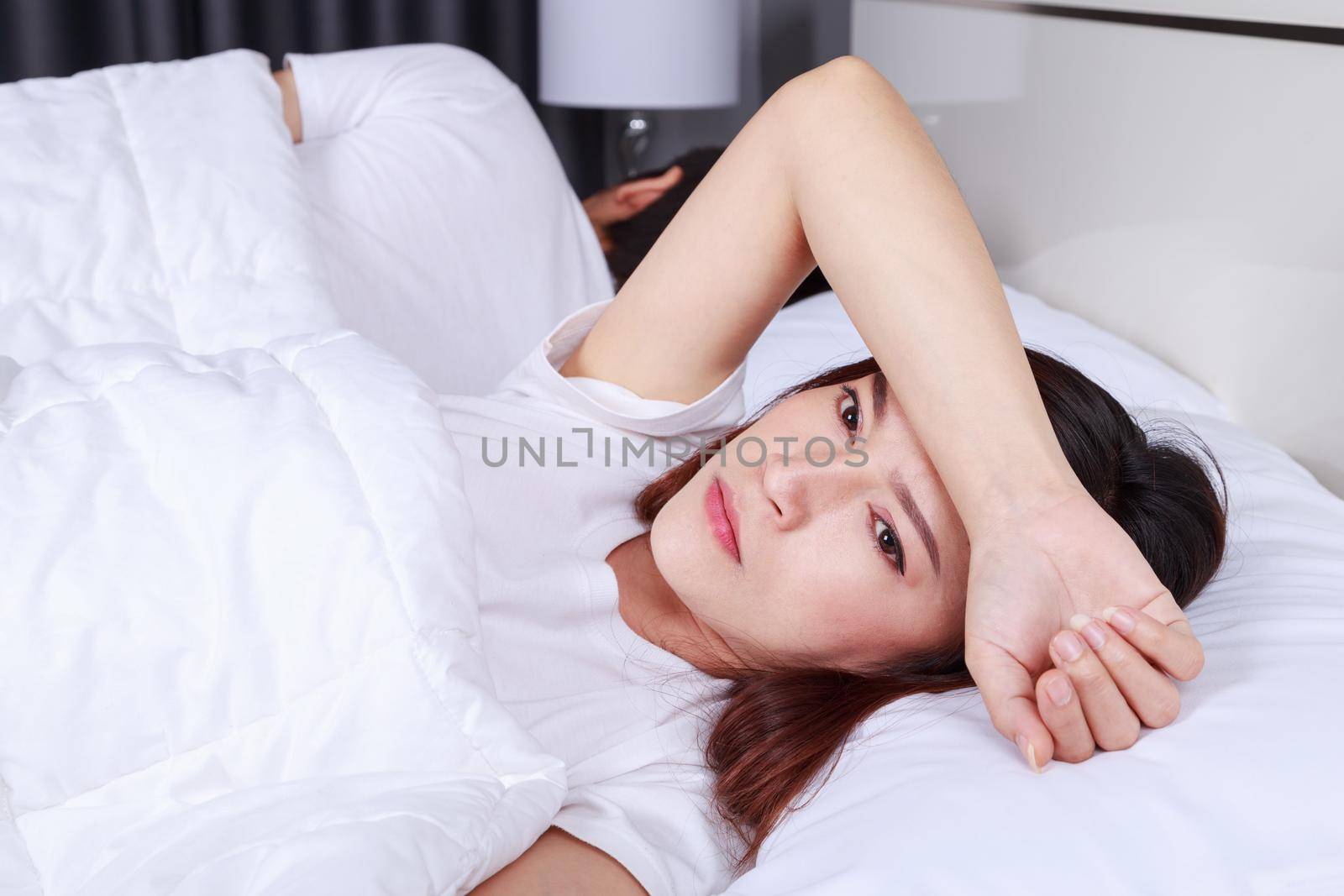 unhappy woman having sleepless on bed in the bedroom