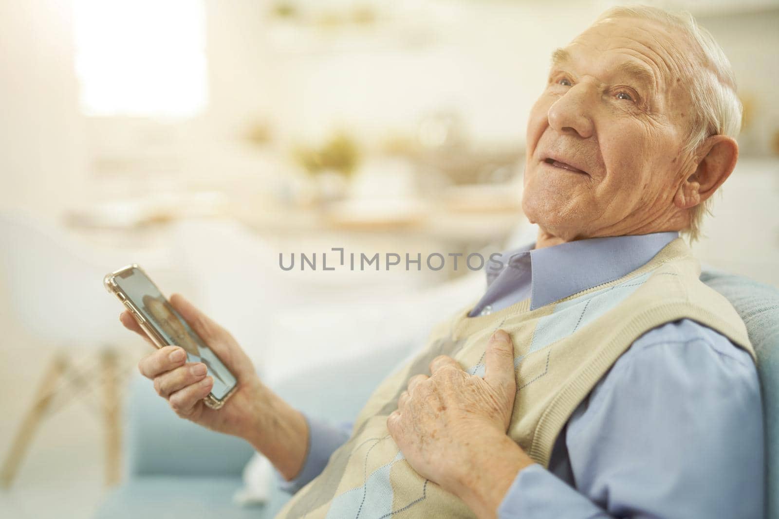 Elderly man pending an online consultation with a therapist by friendsstock