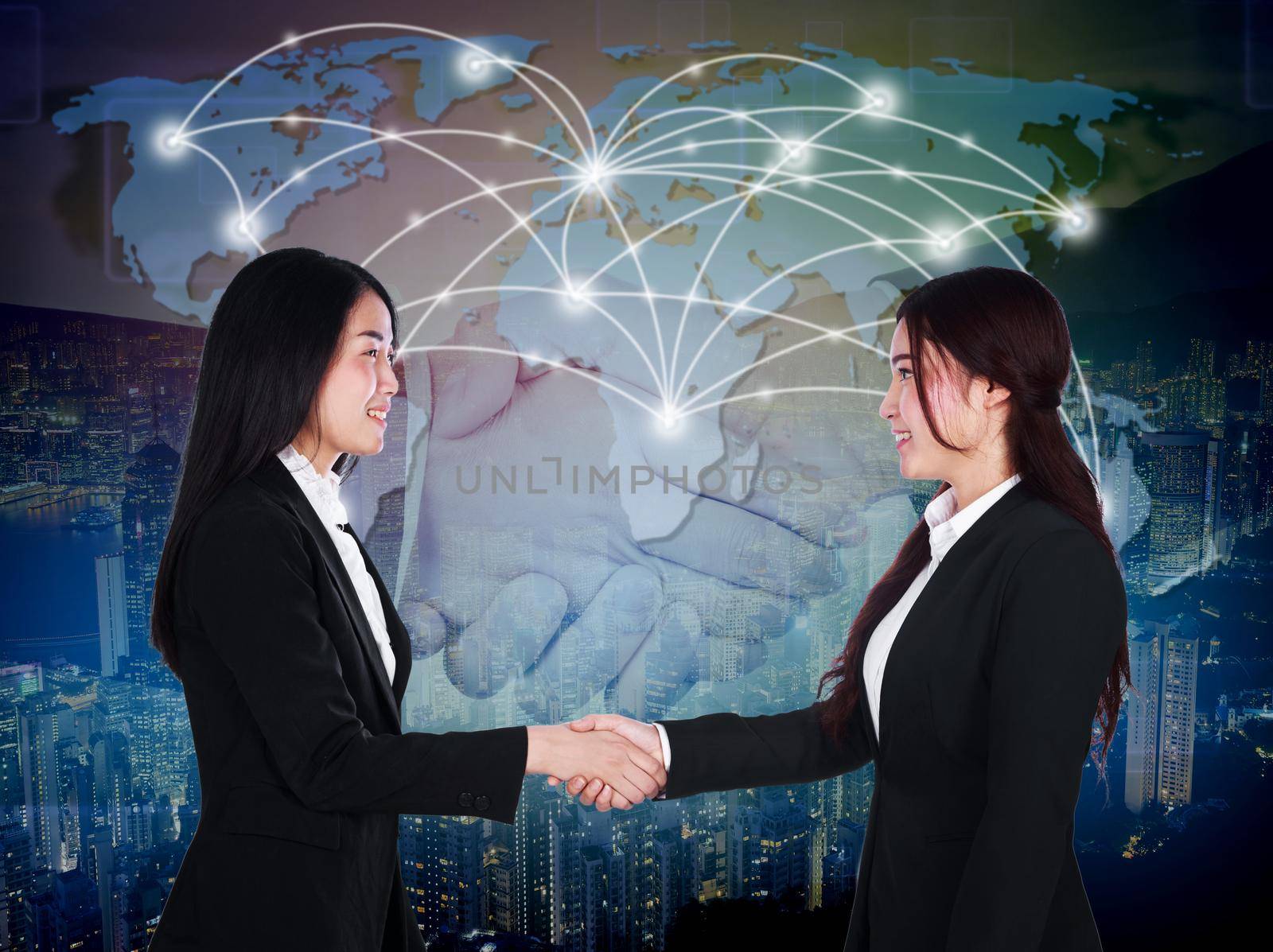 two happy young businesswomen shaking hands  by geargodz