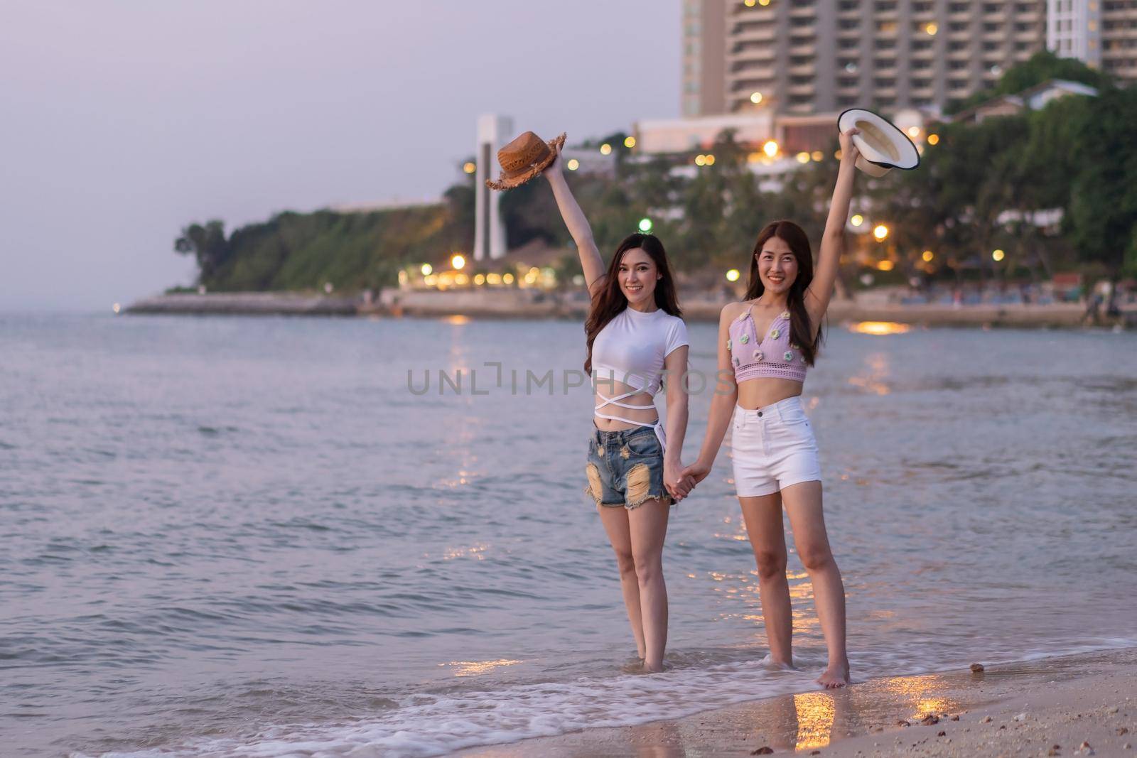 two young women friends enjoy on the sea beach