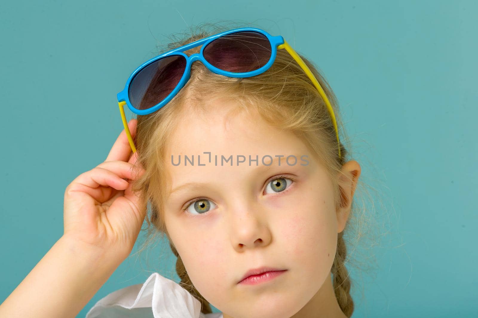 Fashionable little girl in sunglasses. The concept of outdoor recreation, tourism. Isolated.
