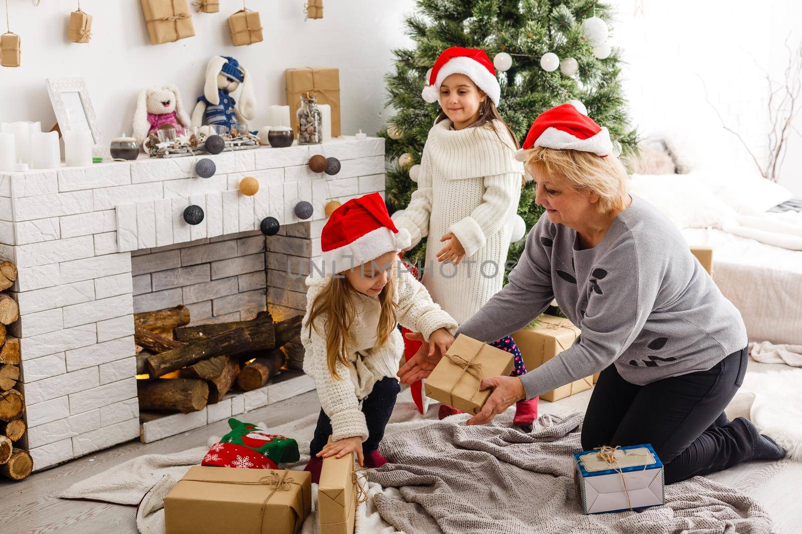 Merry Christmas and Happy Holidays. Grandma and children. The morning Xmas. Portrait loving family.