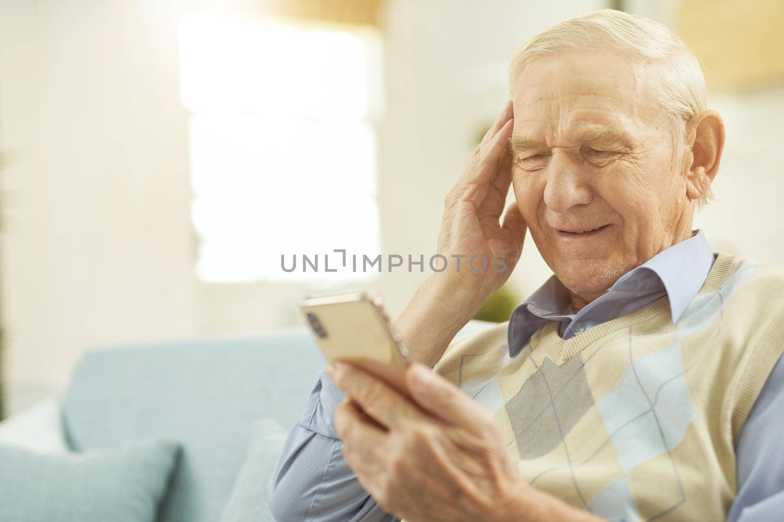 Aged man staying home and talking with therapist online by friendsstock