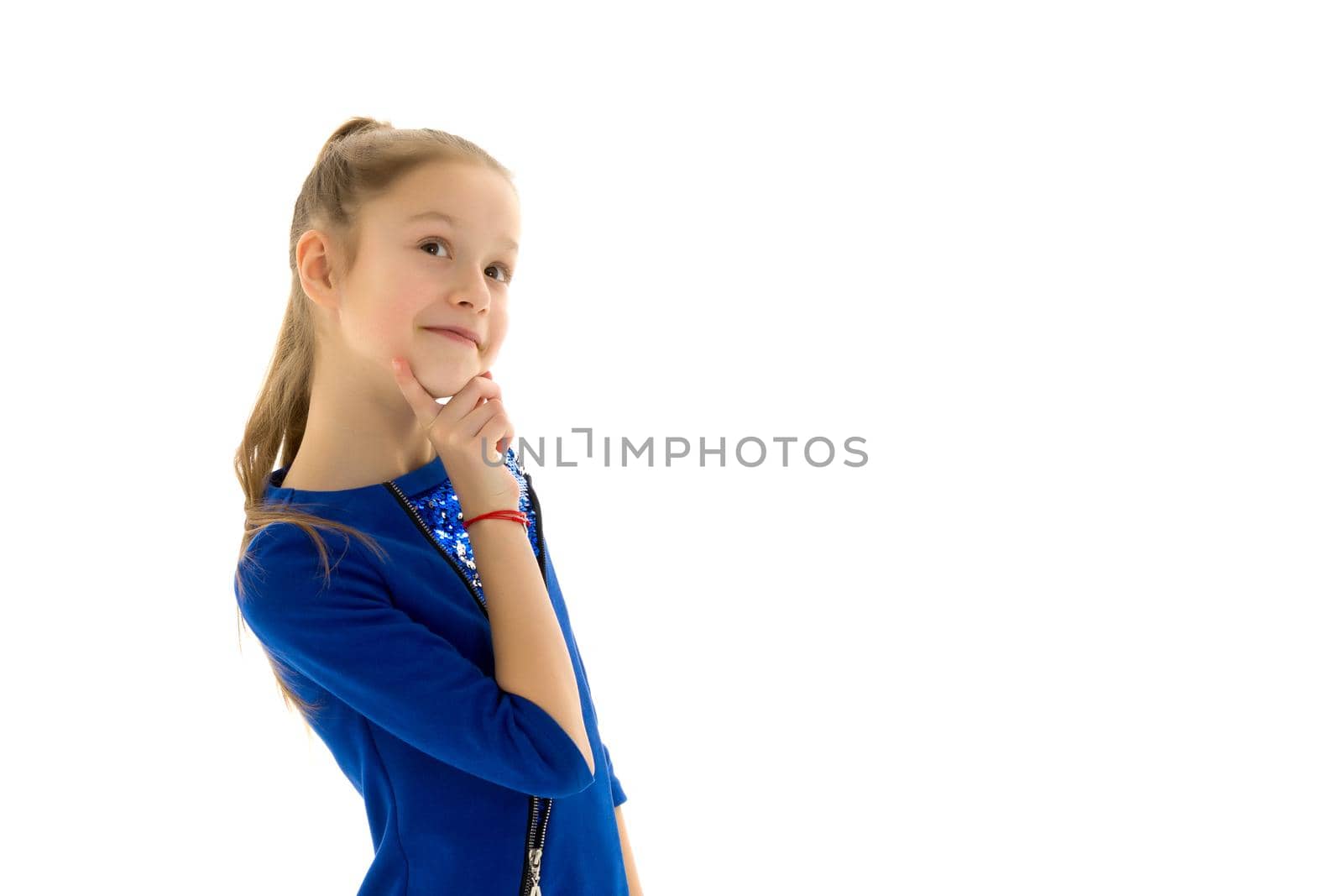 A charming little girl folded her hands around her face. The concept of beauty and fashion, children's emotions. Isolated on white background.