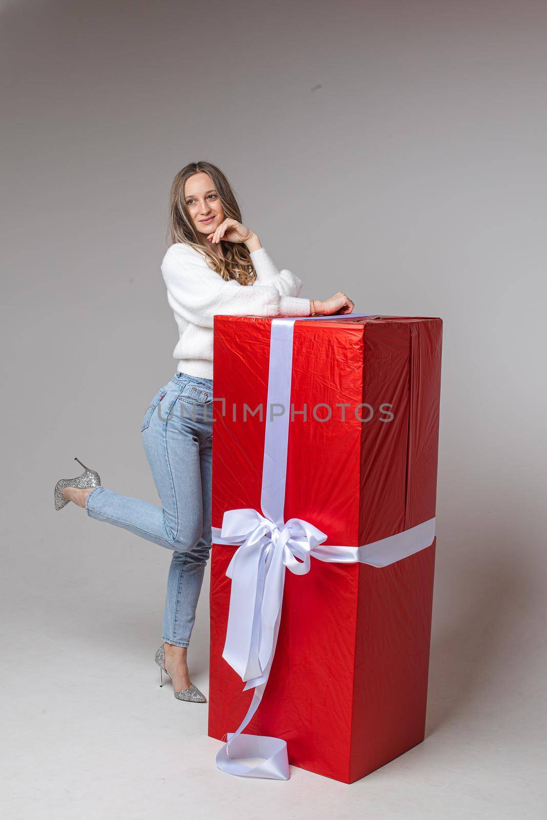 caucasian woman with attractive appearance rejoices of a big present for st. valentine's day, picture isolated on white background