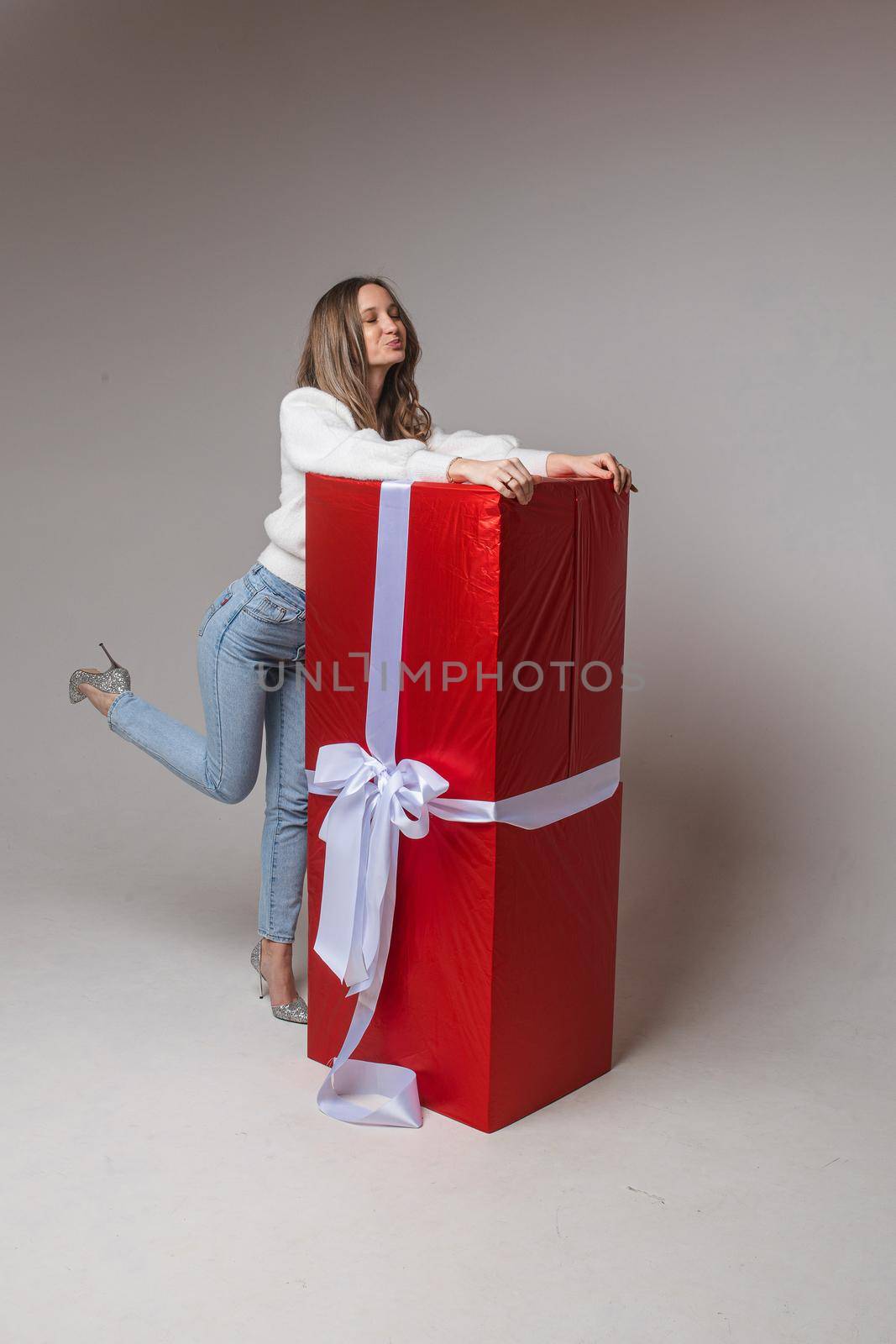 caucasian woman with attractive appearance rejoices of a big present for st. valentine's day, picture isolated on white background