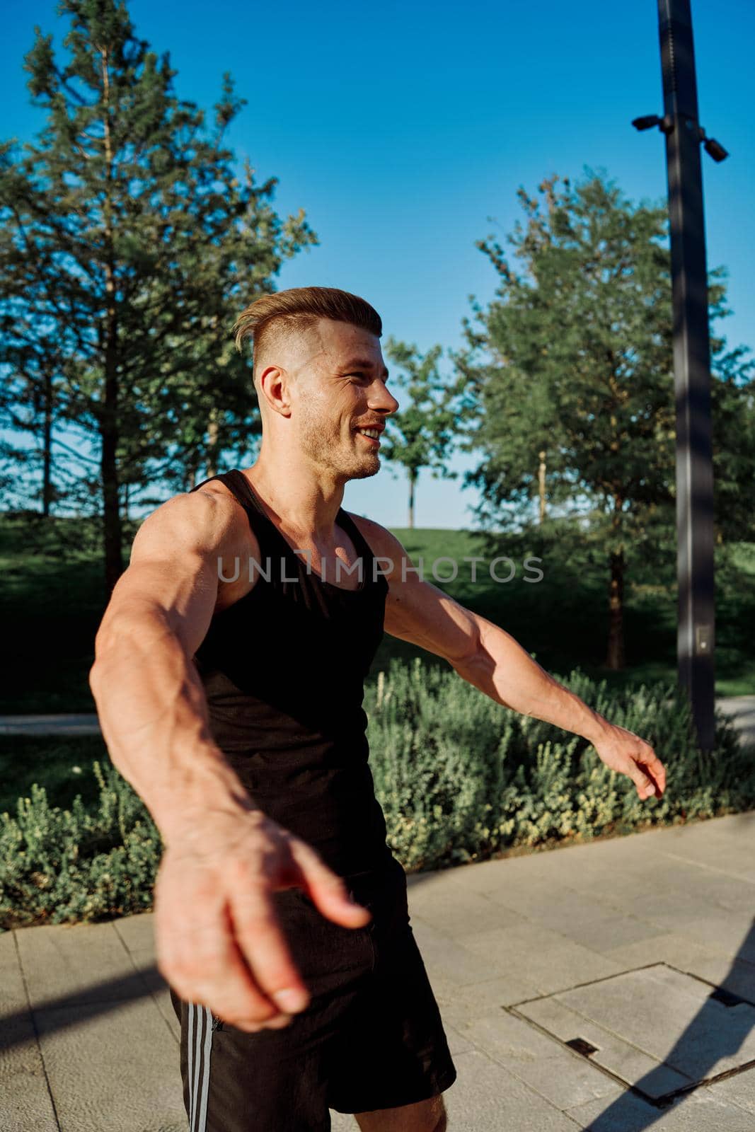 sporty man exercise fitness workout outdoors with dumbbells. High quality photo