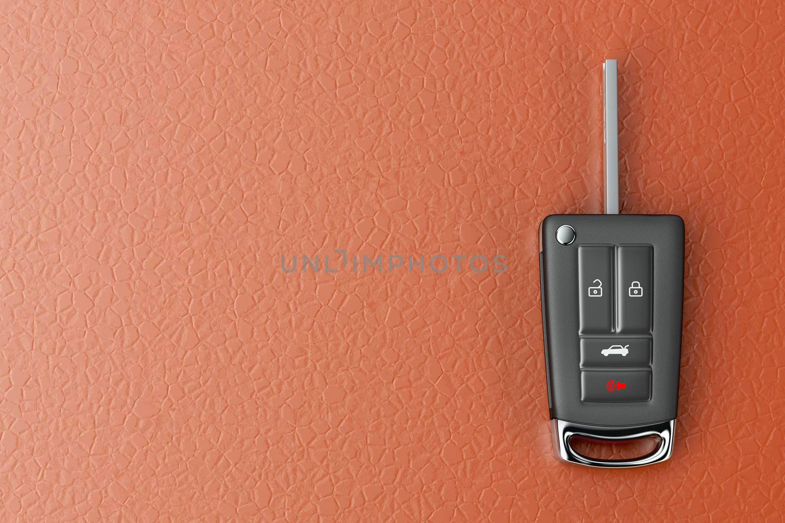 Modern car key on orange colored leather seat, top view
