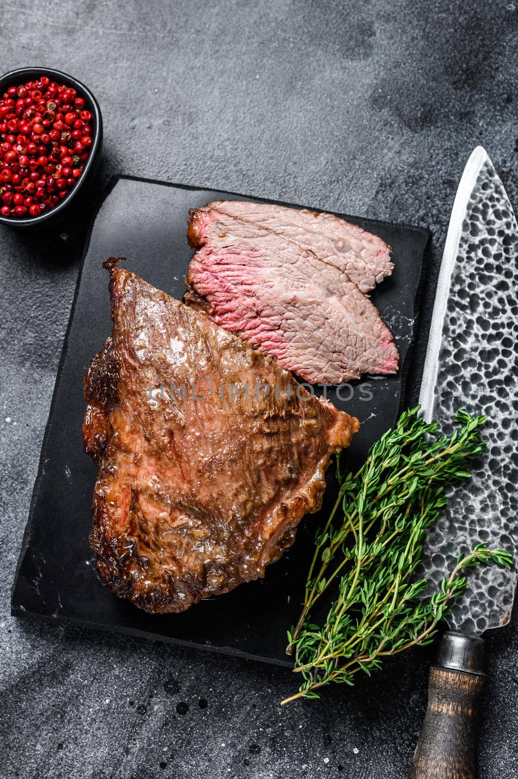 Roast beef tri tip steak bbq. Black background. Top view.