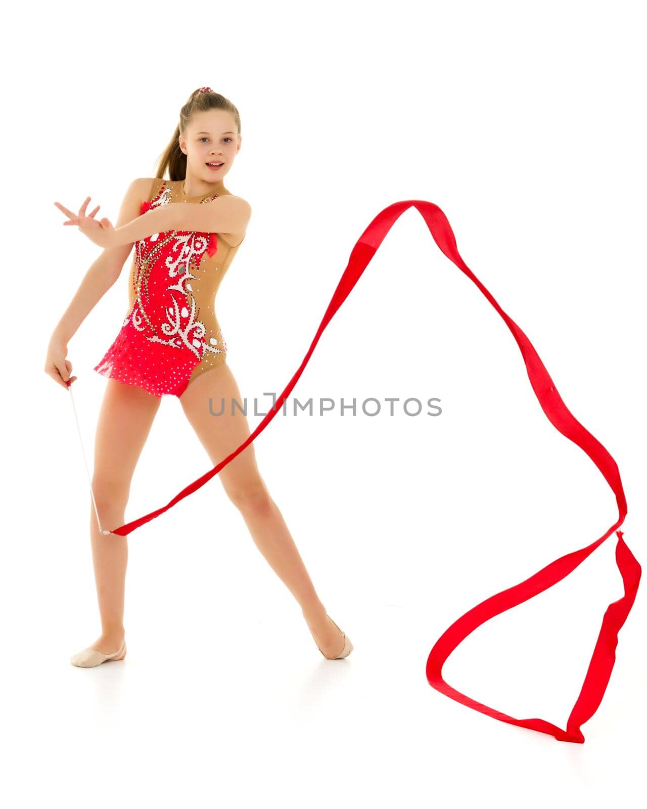 Little girl gymnast performs exercises with tape. The concept of sport, competition. Isolated on white background.