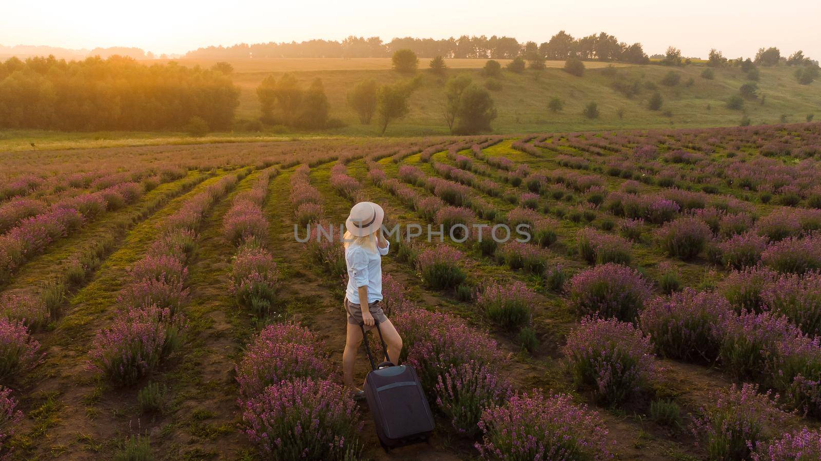 women with a suitcase and lavender field