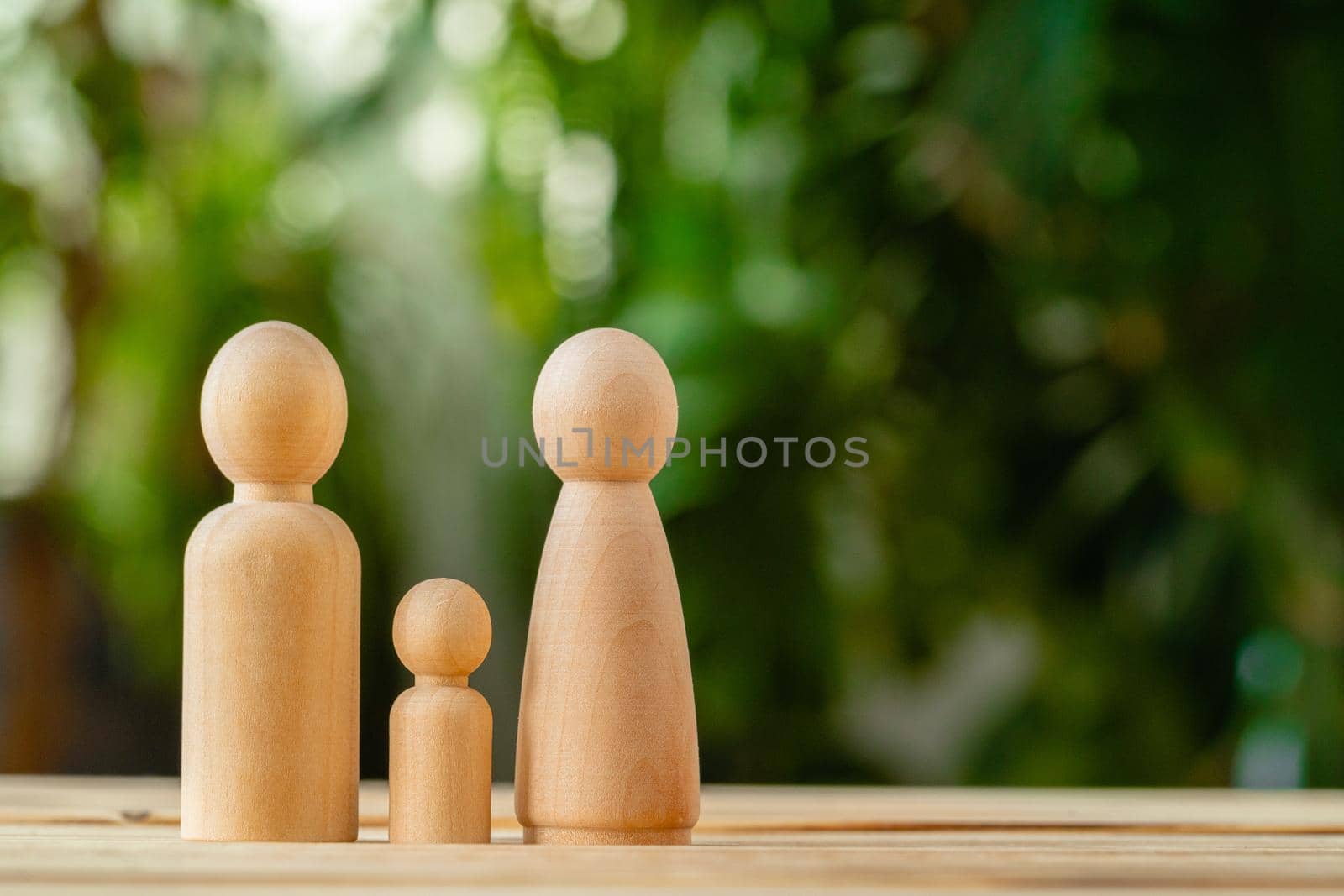 Wooden little figures of people close up. Family concept