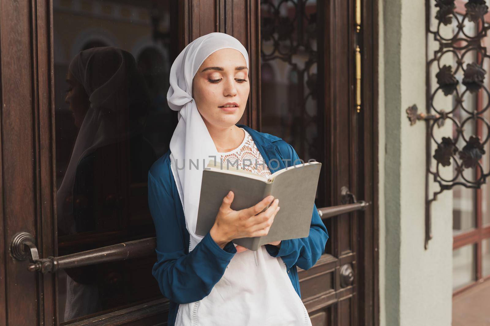 Young muslim girl wears hijab with diary book. Islamic student and knowledge concept