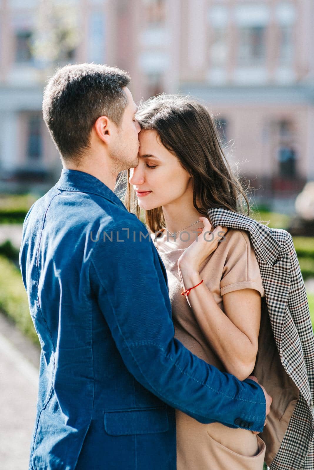 guy and a girl happily walk in the morning on the empty streets of old Europe