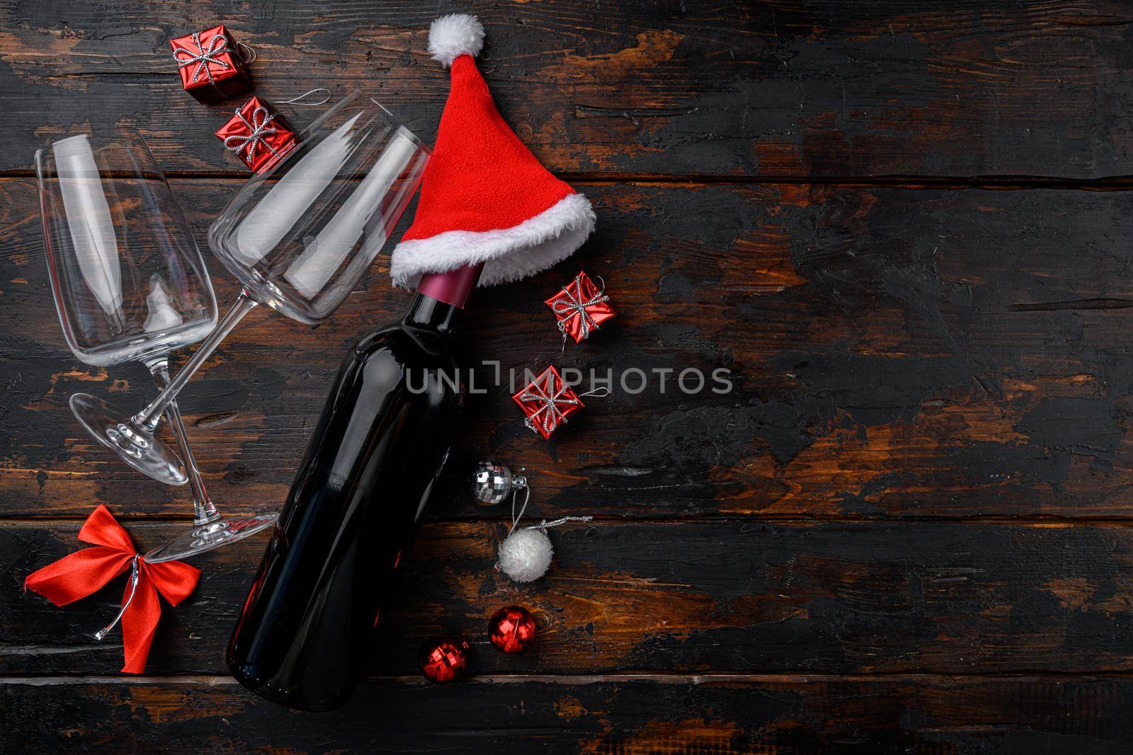 Christmas wine with New Year tree decor set, on old dark wooden table background, top view flat lay, with copy space for text