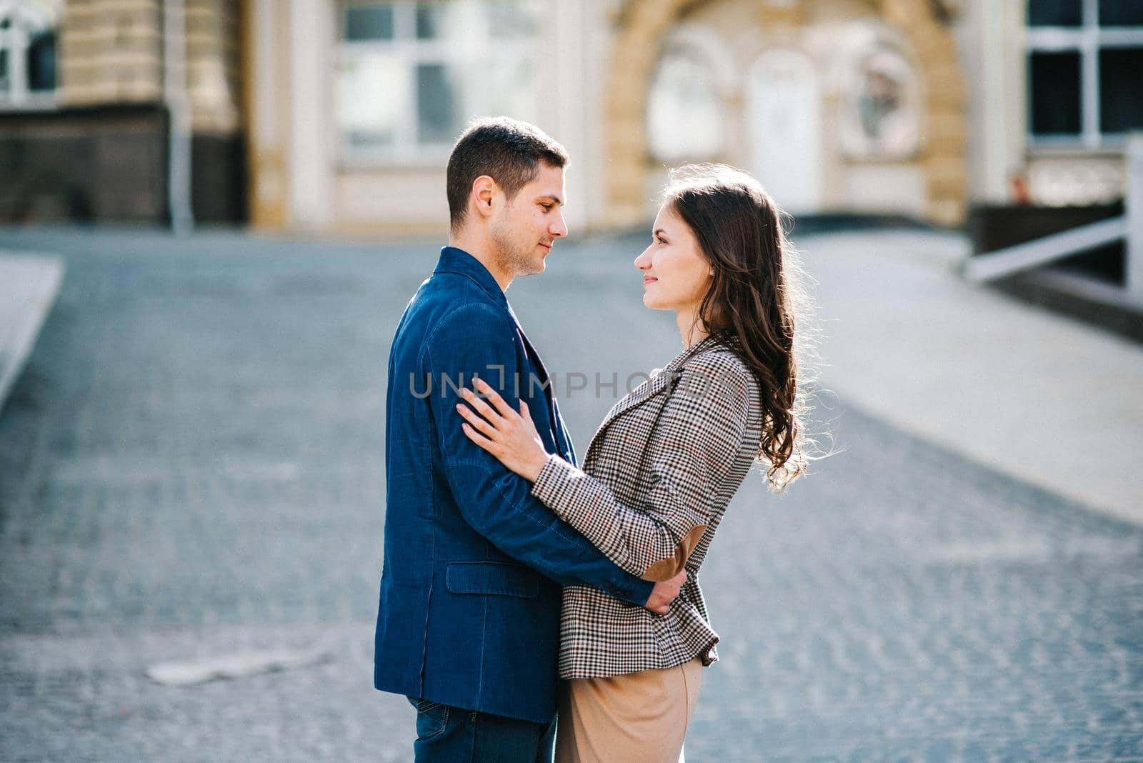 guy and a girl happily walk in the morning on the empty streets of old Europe