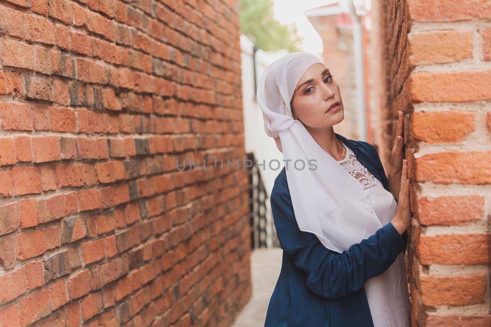 Portrait of female model in fashionable hijab style posing on urban background. Stylish Muslim woman hijab fashion lifestyle portraiture concept