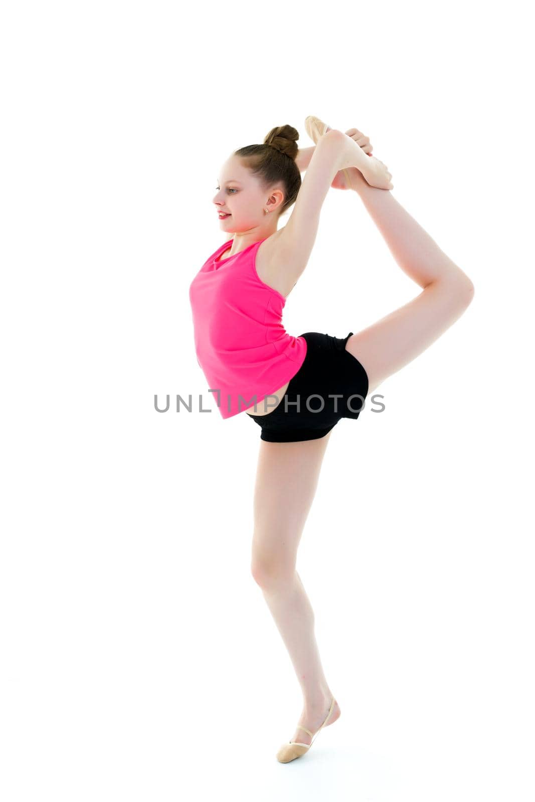 The gymnast balances on one leg. by kolesnikov_studio