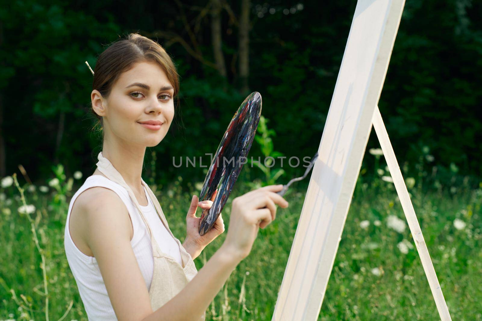 Woman in white dress with palette of paints on nature art drawing by Vichizh