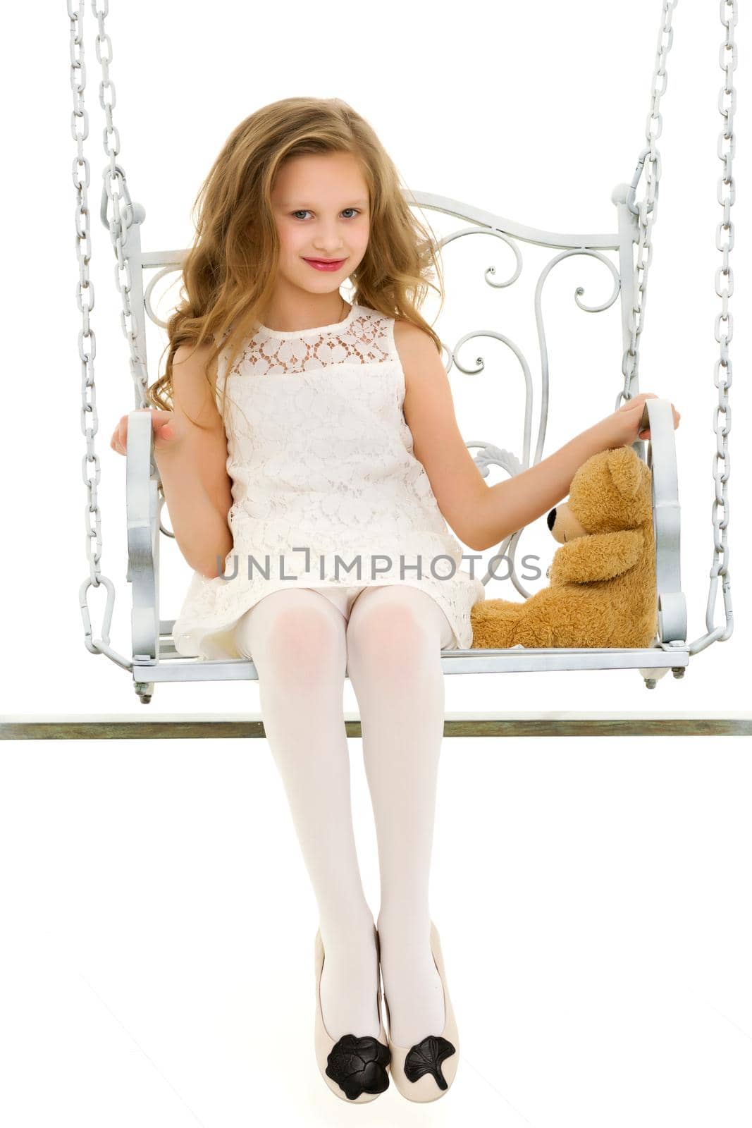Beautiful Blonde Girl in Elegant White Dress Swinging Her Teddy Bear on Swing, Portrait of Lovely Long Haired Girl Wearing Stylish Clothes Smiling at Camera Against White Background