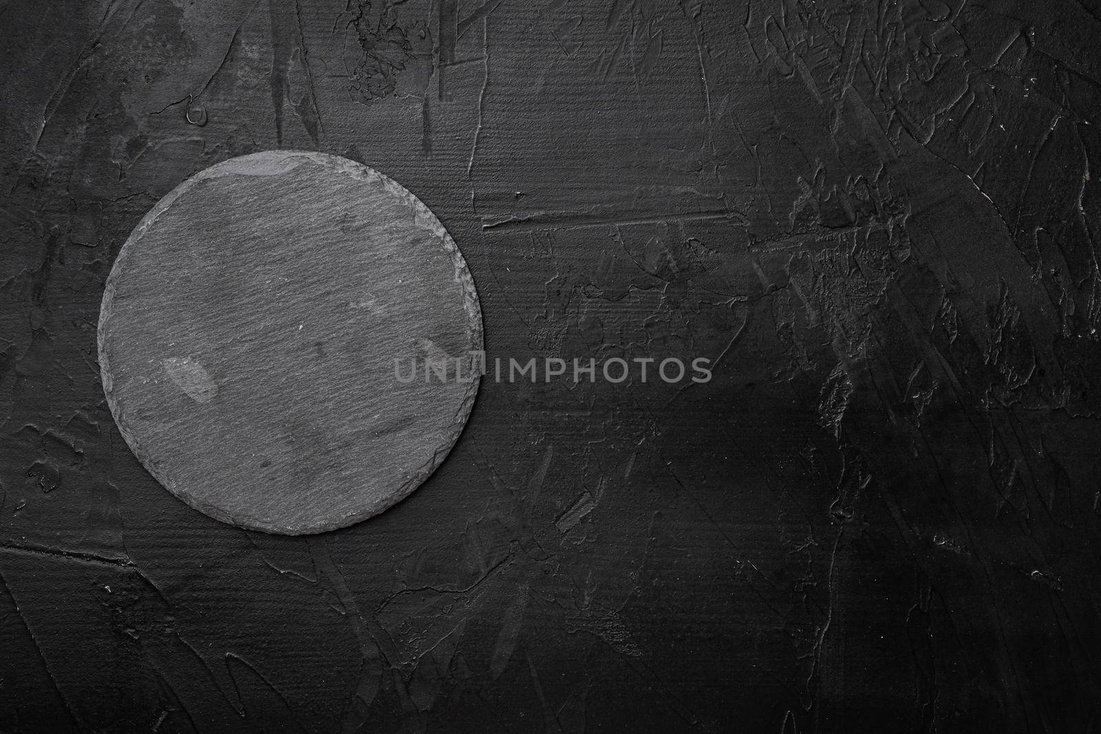 Slate stone cutting board set with copy space for text or food with copy space for text or food, top view flat lay, on black dark stone table background