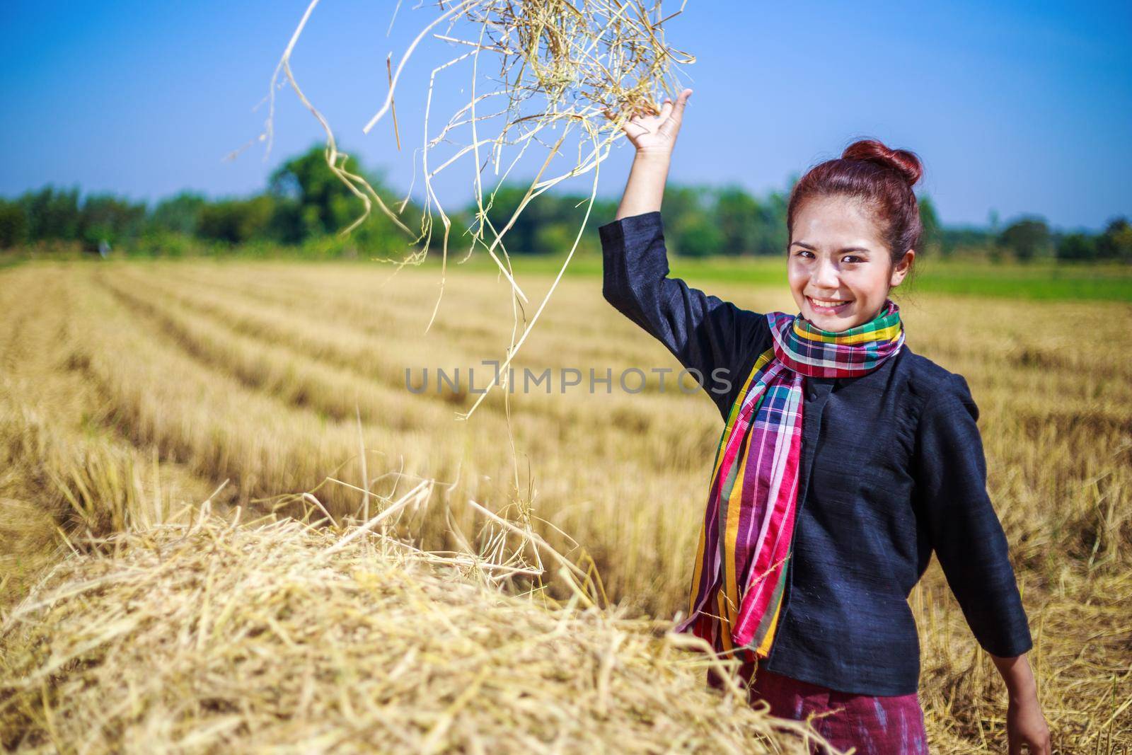 farmer woman relaxing with the straw in field, Thailand