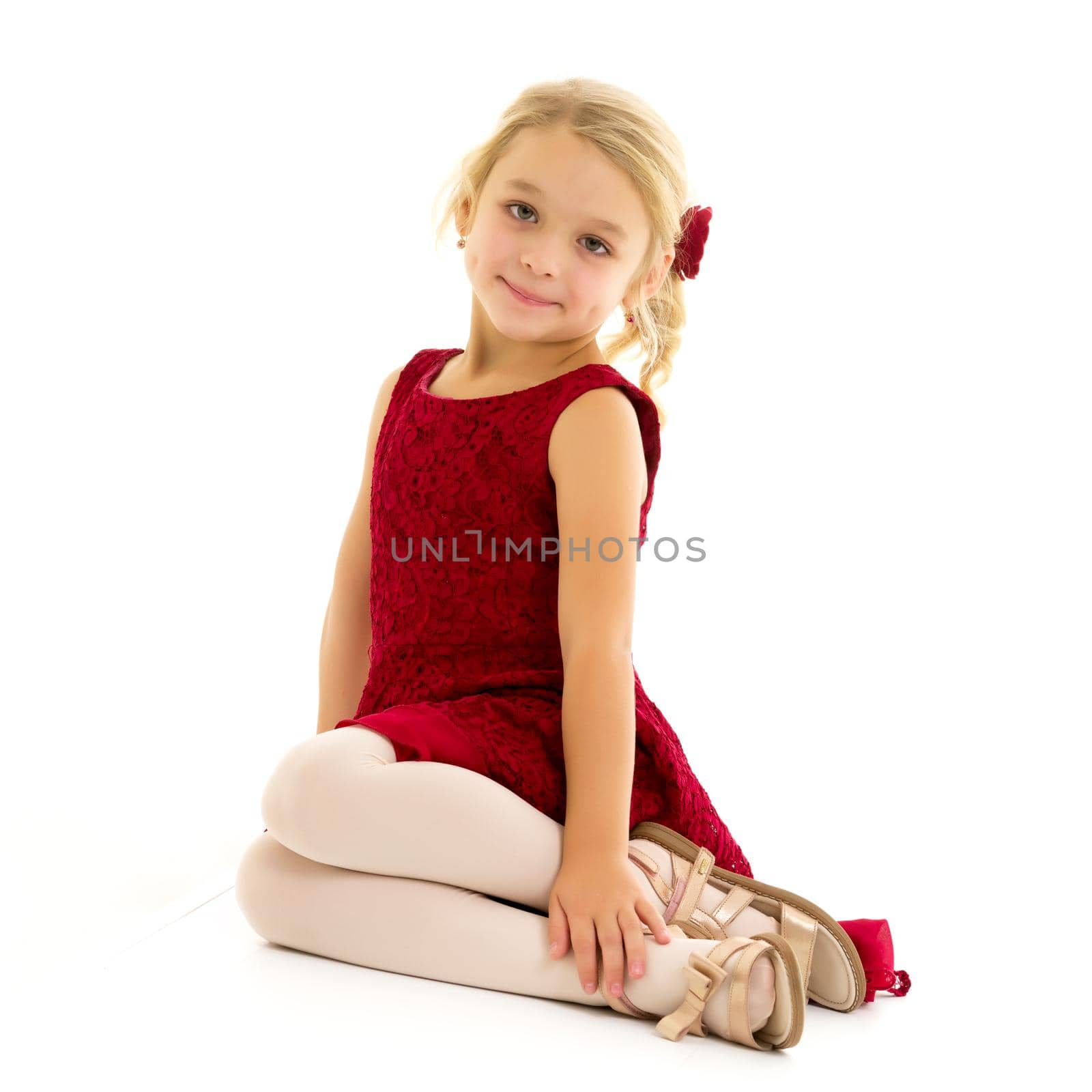 Little girl is sitting on the floor.The concept of a happy child by kolesnikov_studio