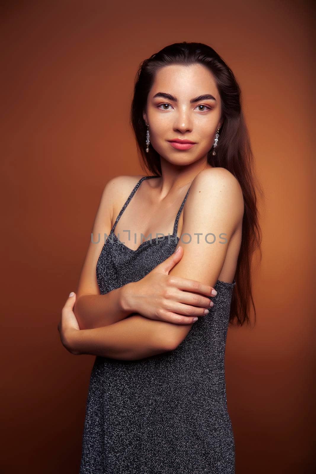 pretty girl happy posing: brunette on brown background, lifestyle people concept closeup