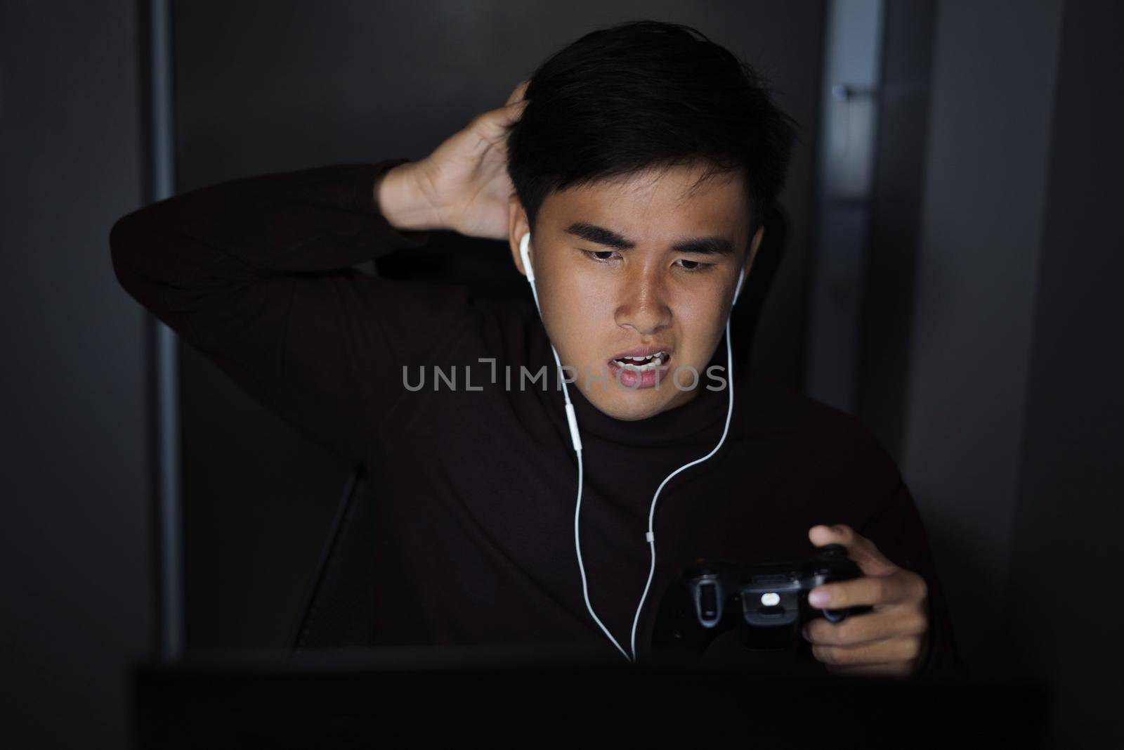 Stressed depressed man using joystick to playing games by geargodz