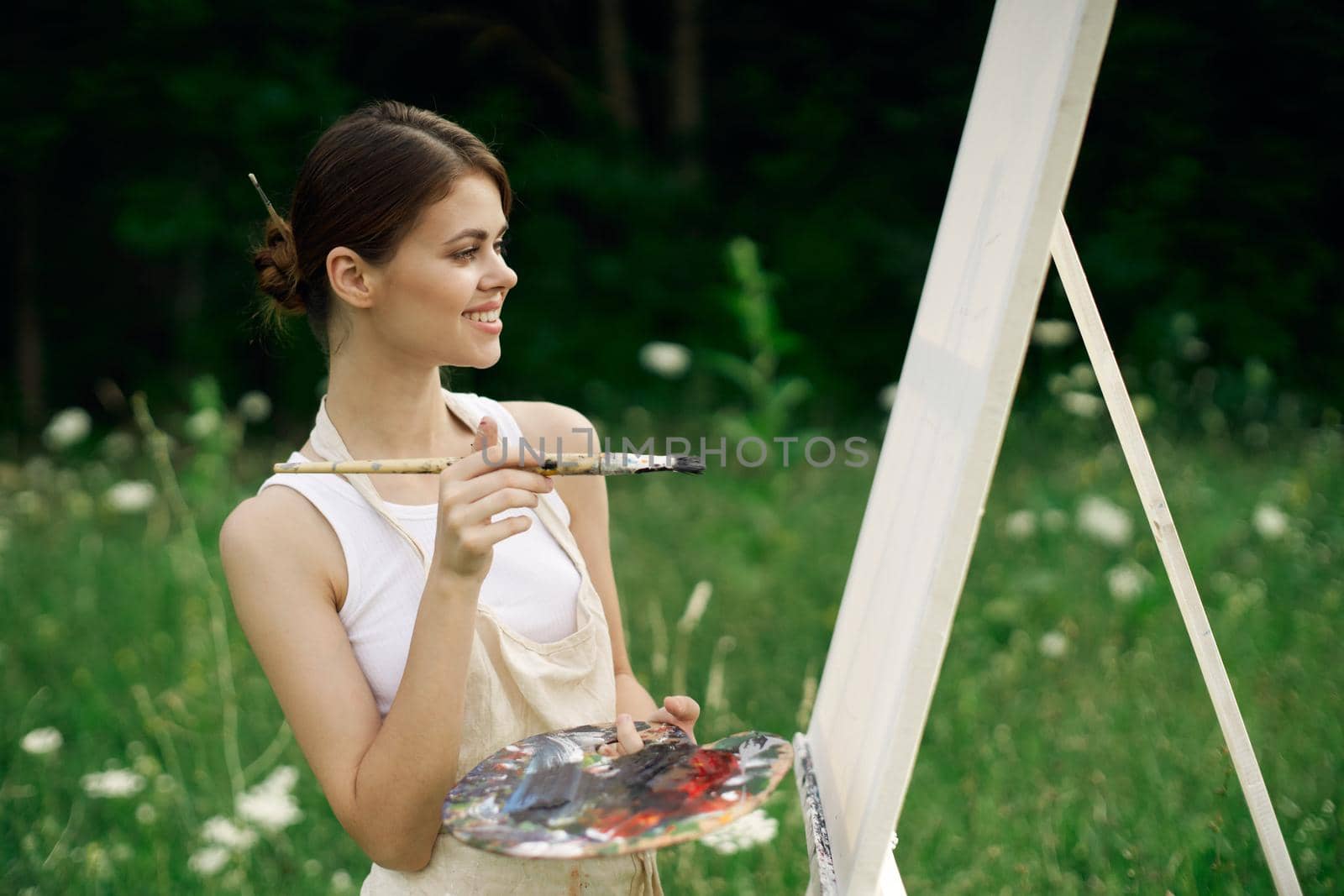 woman outdoors paint a picture landscape hobby creative. High quality photo