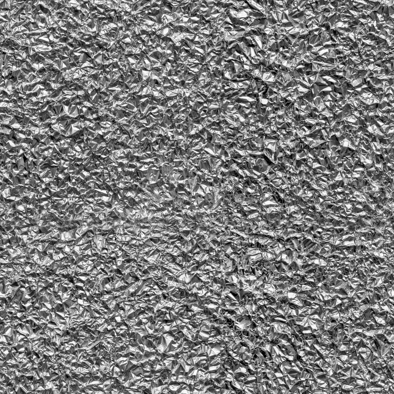 Seamless texture of crumpled aluminum leaf foil, close-up.