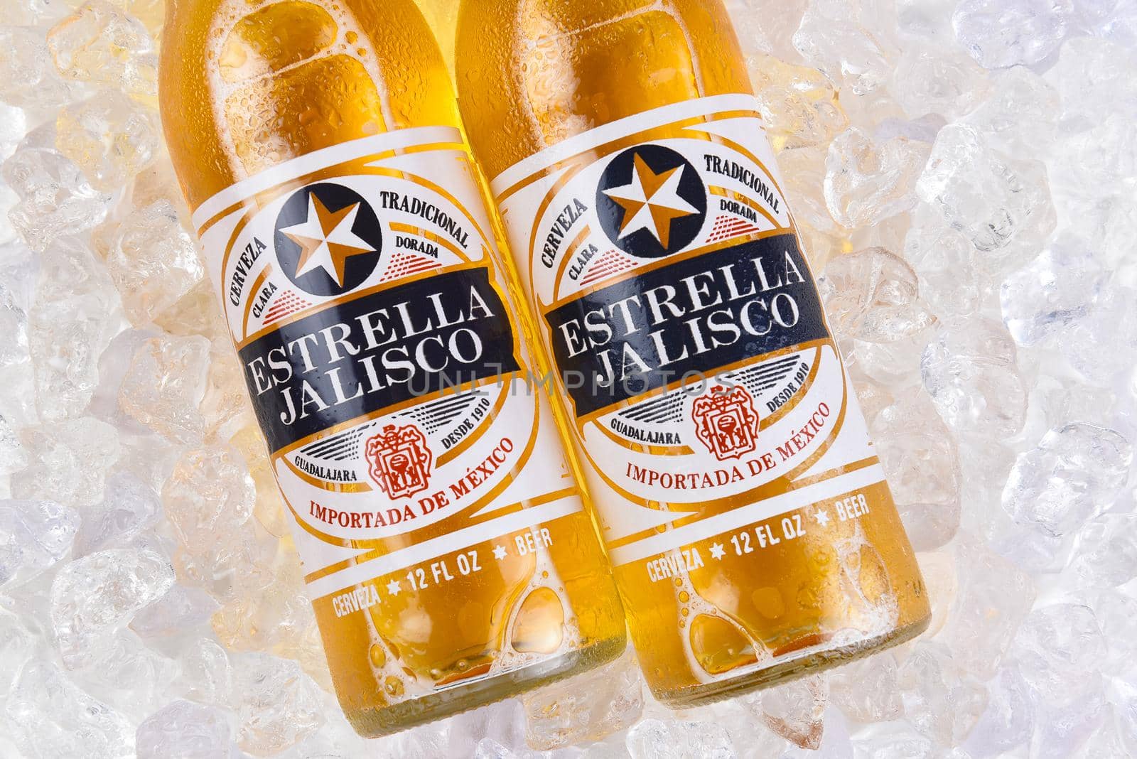 IRVINE, CALIFORNIA - MARCH 21, 2018: Two bottles of Estrella Jalisco Beer in ice closeup. Estrella Jalisco is a American Lager style beer brewed by Grupo Modelo.