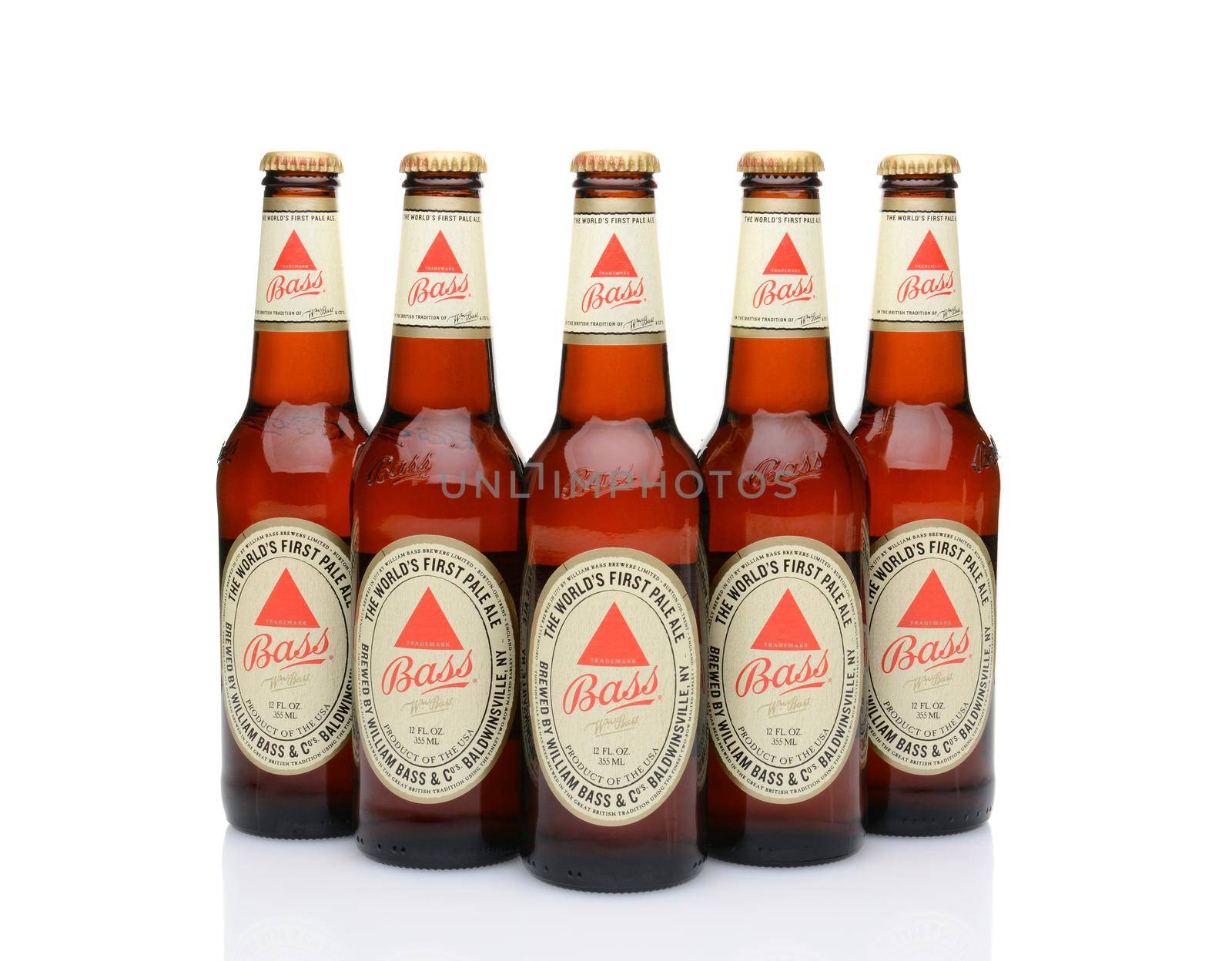 IRVINE, CA - MAY 25, 2014: Five bottles of Bass Ale on white. The Bass Brewery was founded in 1777 by William Bass, in Trent, England is now owned by Anheuser-Busch InBev.