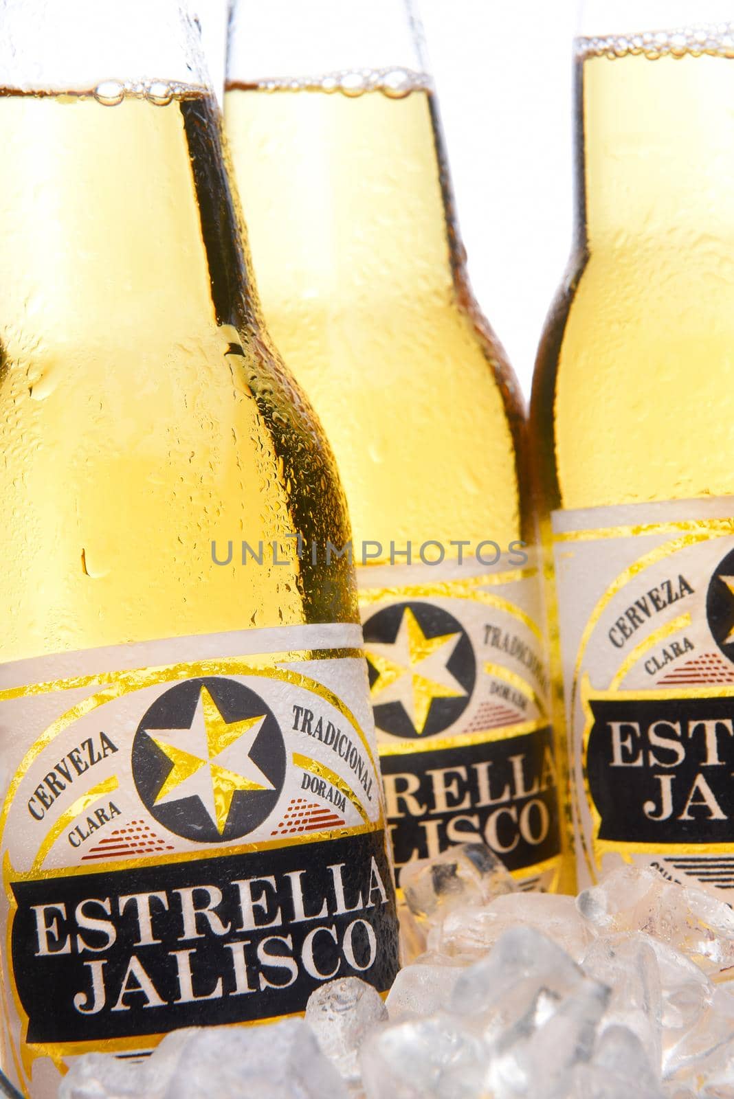 IRVINE, CALIFRONIA - MARCH 29, 2018: Closeup of three bottles of Estrella Jalisco beer in ice.  Estrella Jalisco is a American Lager style beer brewed by Grupo Modelo.