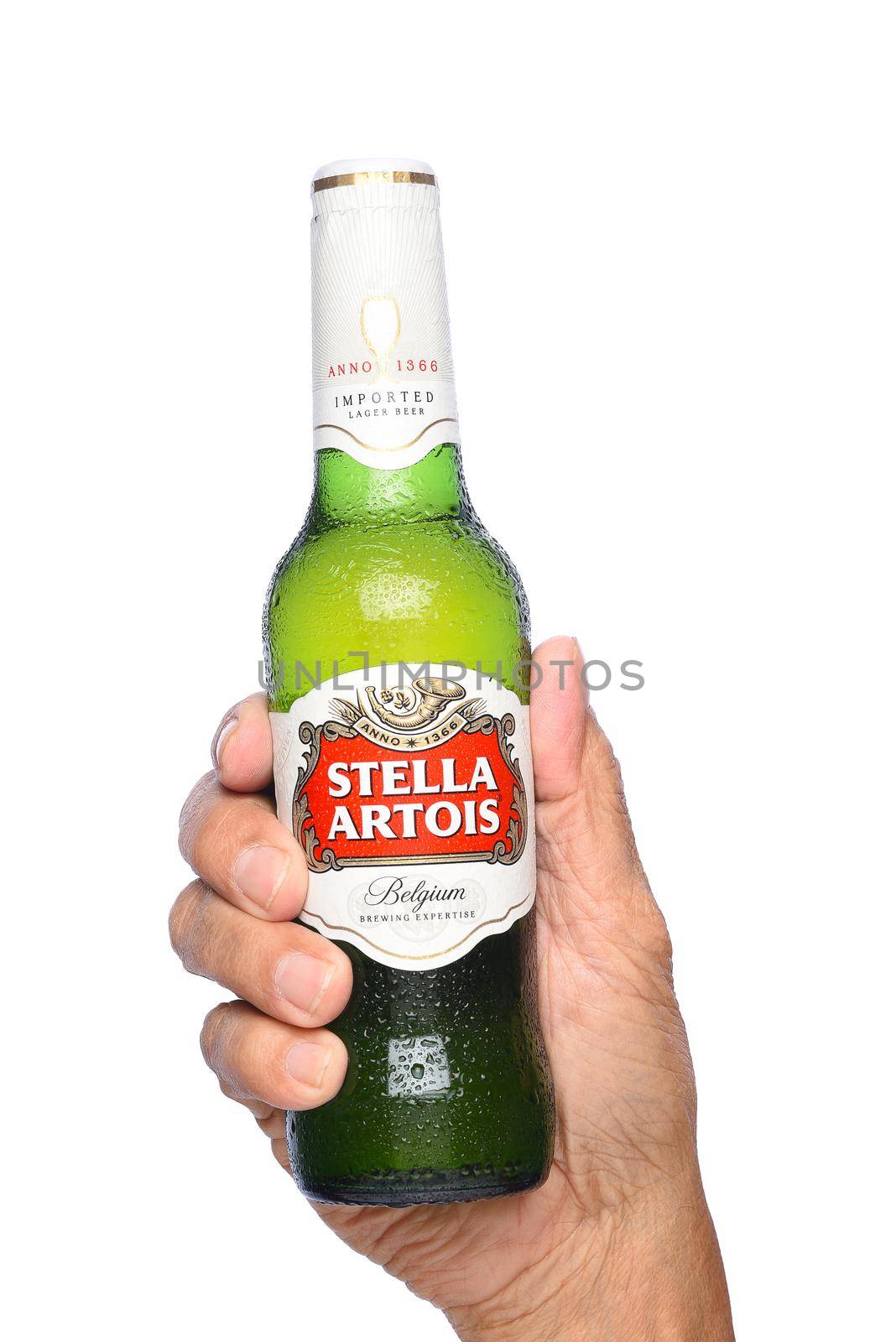 IRVINE, CALIFORNIA - APRIL 26, 2019: Closeup of a hand holding a bottle of Stella Artois Beer. Stella is brewed in Leuven, Belgium, and launched as a festive beer, named after the Christmas star.