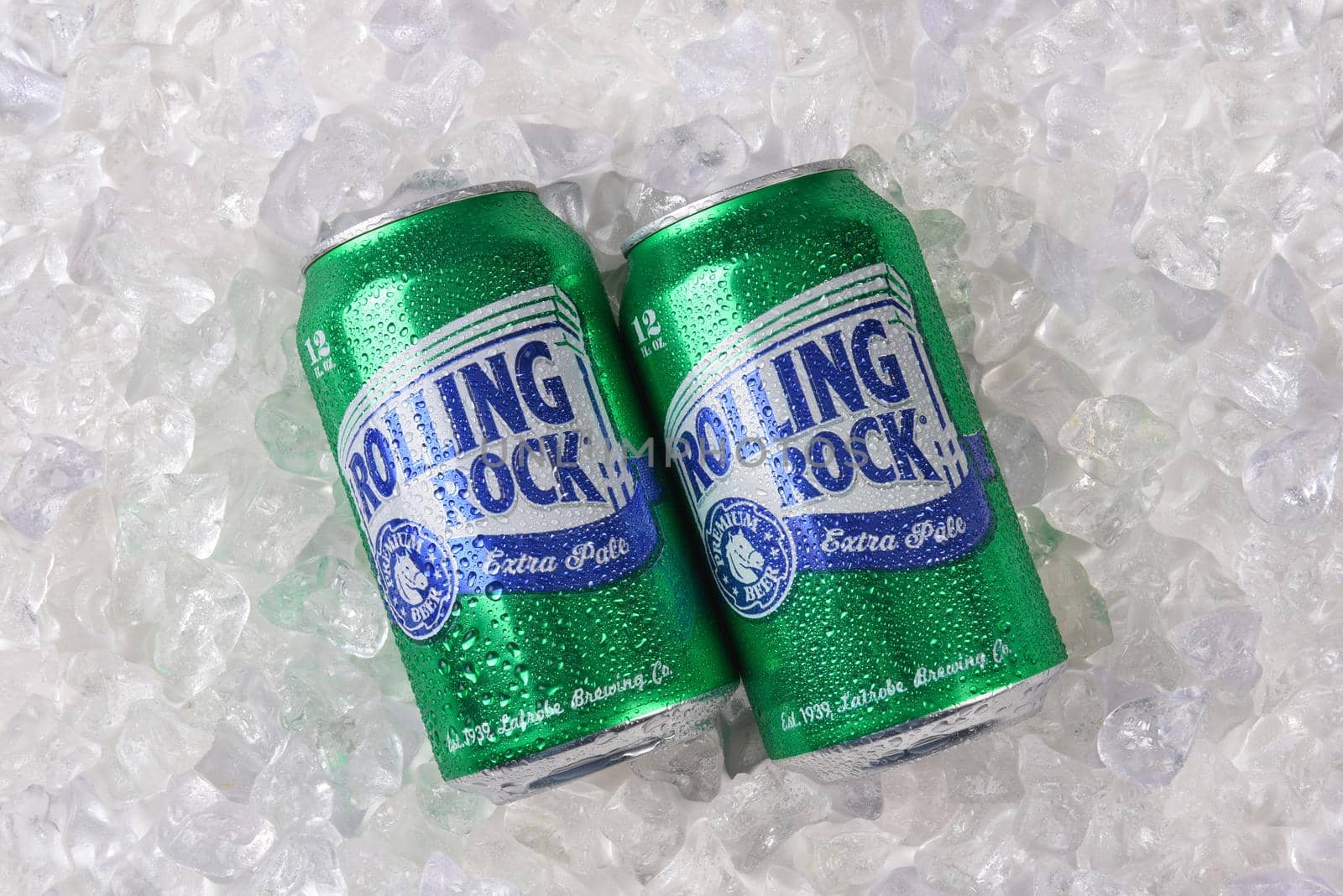 IRVINE, CALIFORNIA, FEBRUARY 7, 2018: Rolling Rock Extra Pale Beer. Two cans of the American beer, on ice, founded in 1939 in Latrobe, Pennsylvania.