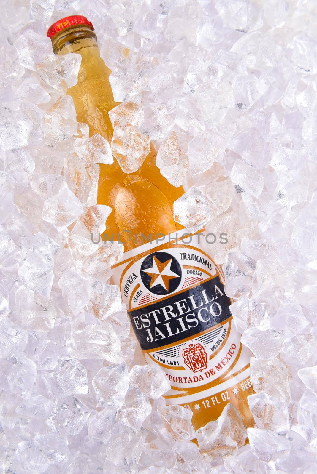 IRVINE, CALIFORNIA - MARCH 29, 2018: Closeup of a bottle of Estrella Jalisco beer in ice.  Estrella Jalisco is a American Lager style beer brewed by Grupo Modelo.