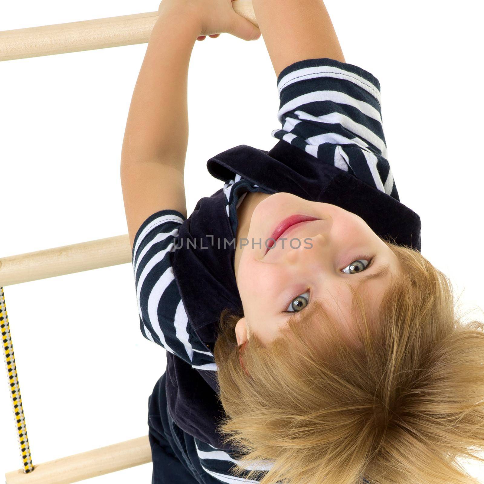 Cute little boy climbing rope ladder by kolesnikov_studio