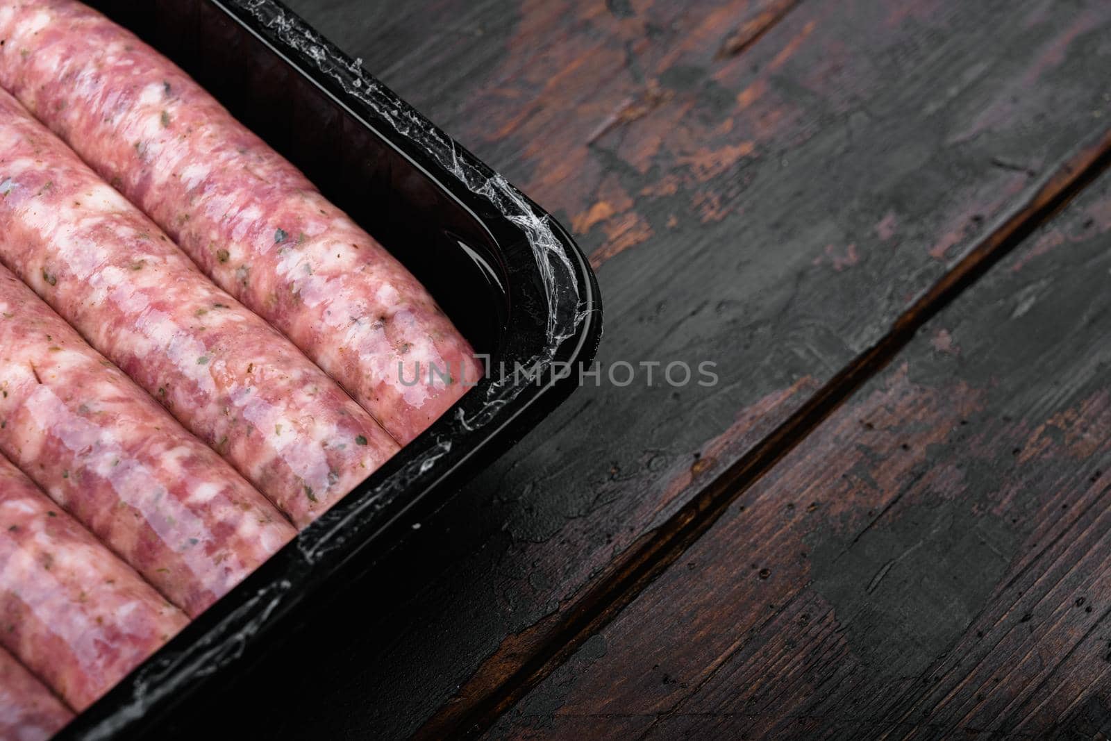 Fresh Polish Sausages pack set, on old dark wooden table background, with copy space for text