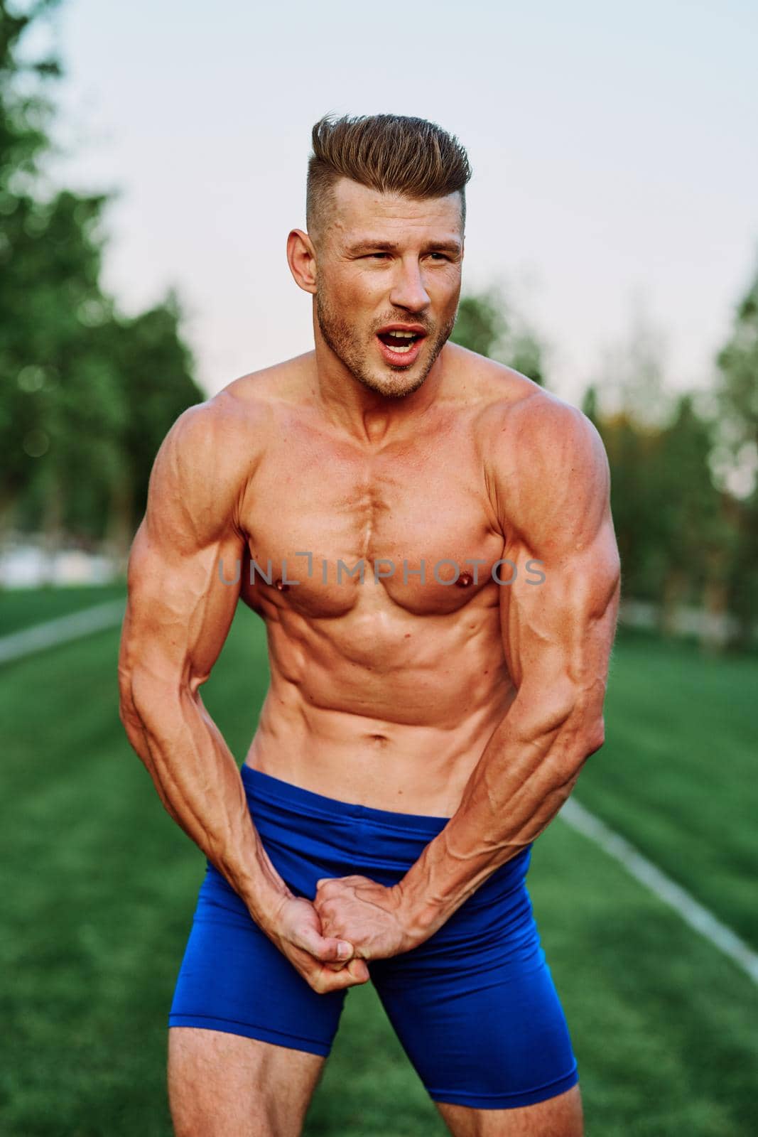 man with pumped up muscular body outdoors health workout. High quality photo