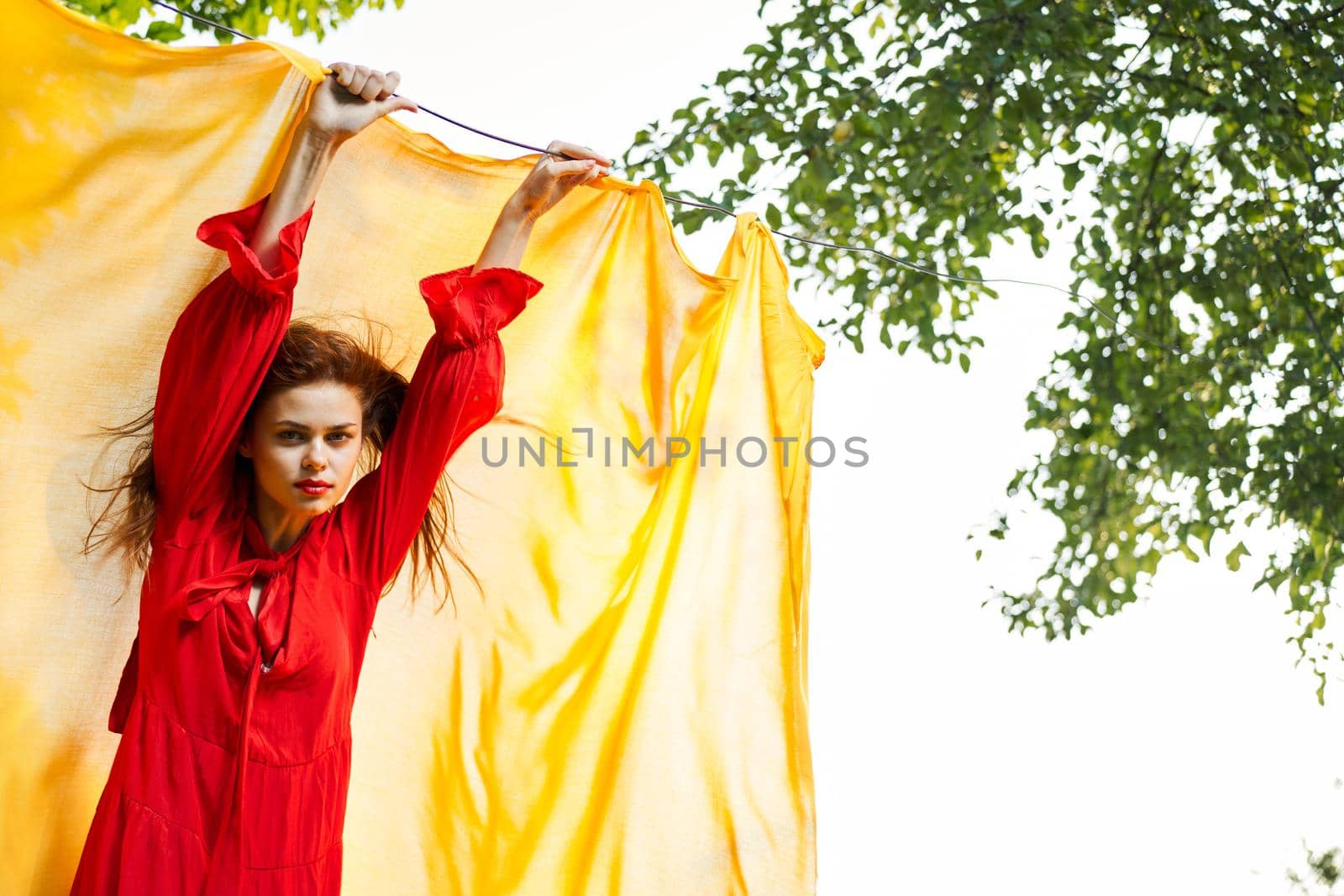 woman in red dress outdoors yellow bedspread by Vichizh