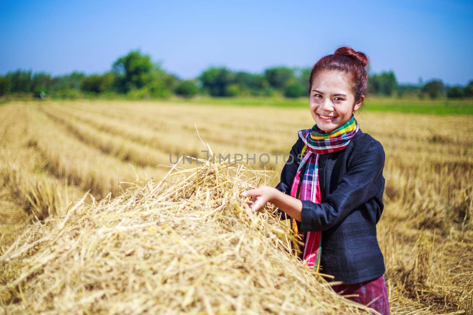 farmer woman relaxing with the straw in field, Thailand
