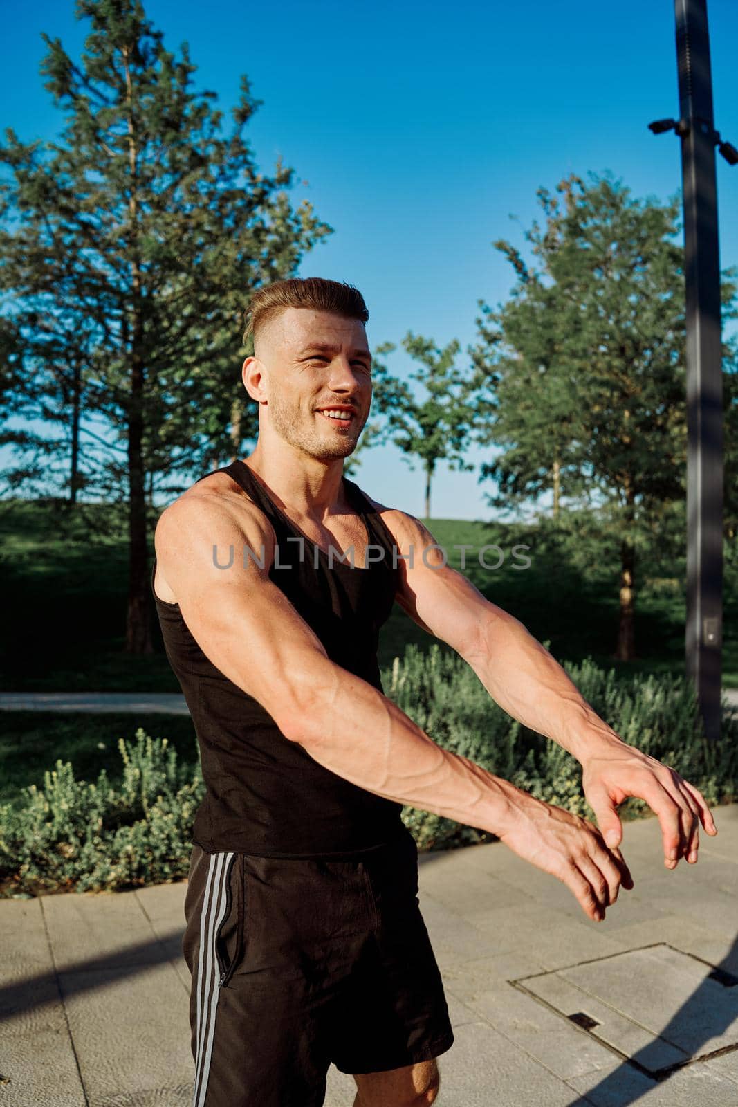 sporty man exercise fitness workout outdoors with dumbbells. High quality photo