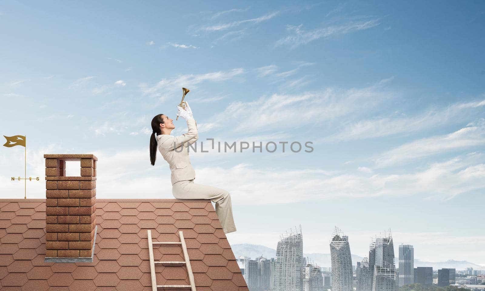 Elegant young woman playing trumpet on edge of roof. Girl in white business suit and gloves with music brass instrument posing on roof of building. Blue sky and modern metropolis with skyscrapers.