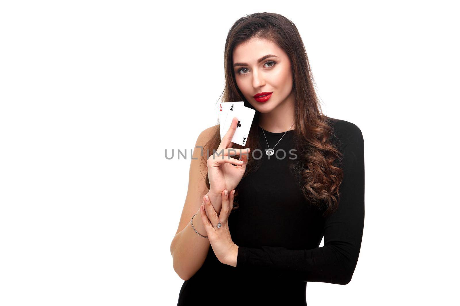 Sexy curly hair brunette in black dress posing with two aces cards in her hands, poker concept isolation on white background. winning combination