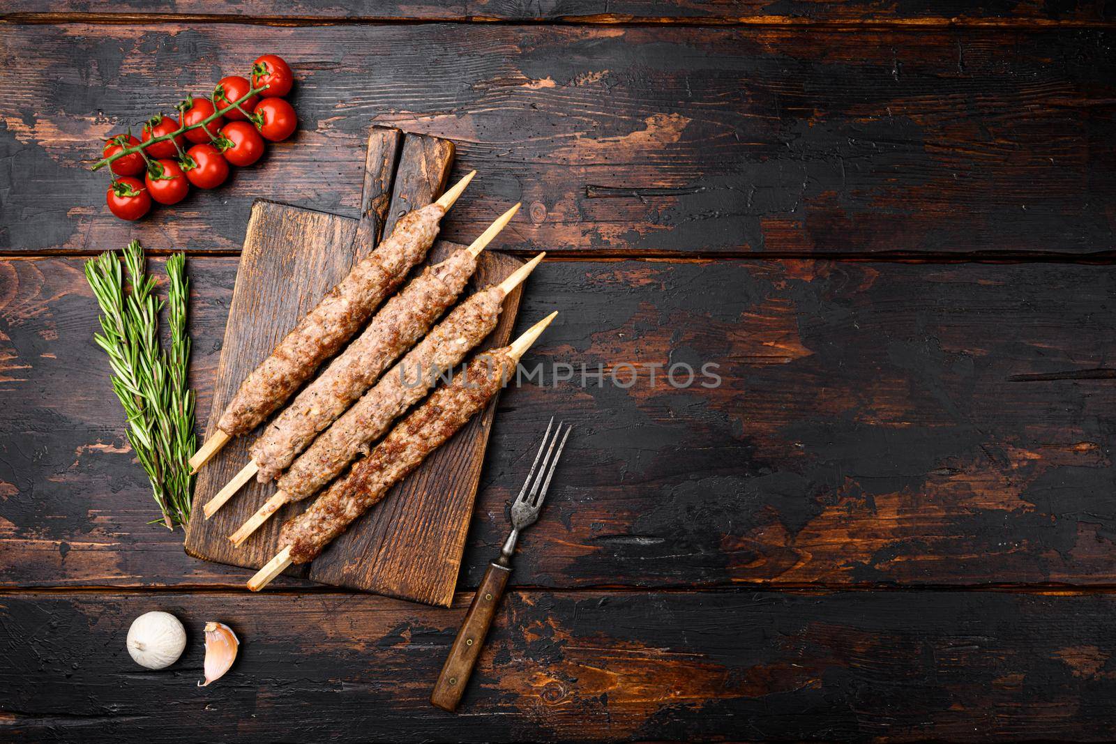 Tikka, shish and kofta kebabs set, on old dark wooden table background, top view flat lay, with copy space for text