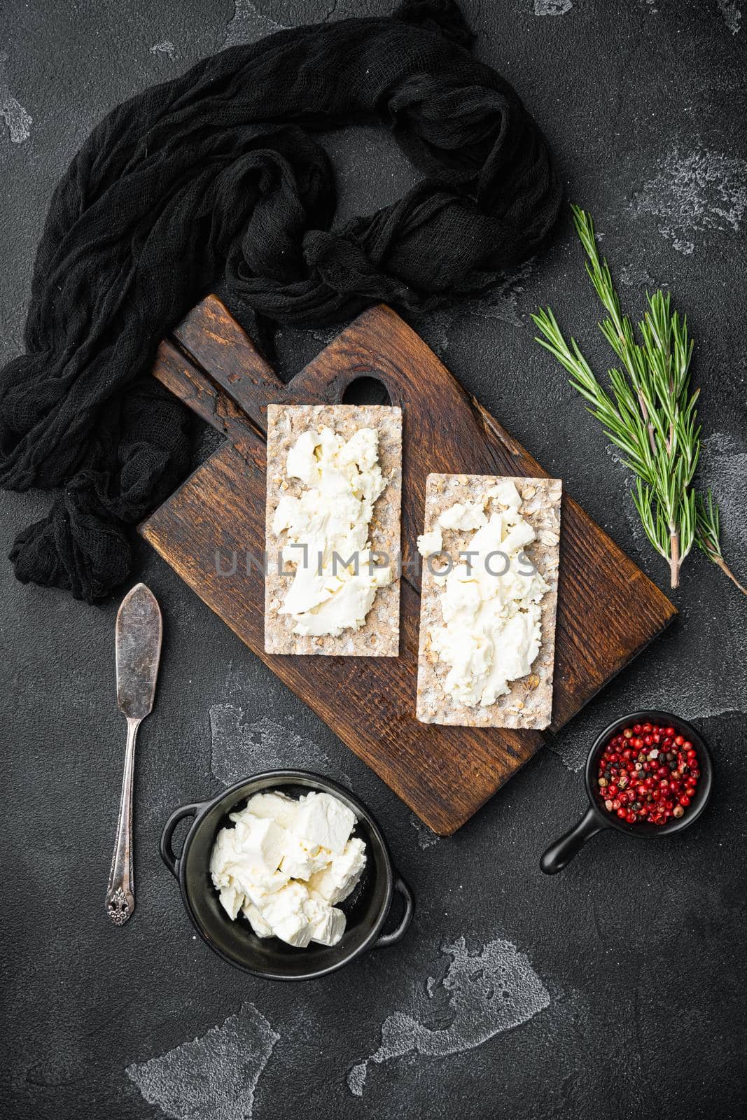 Crispbread sandwich set, on black dark stone table background, top view flat lay