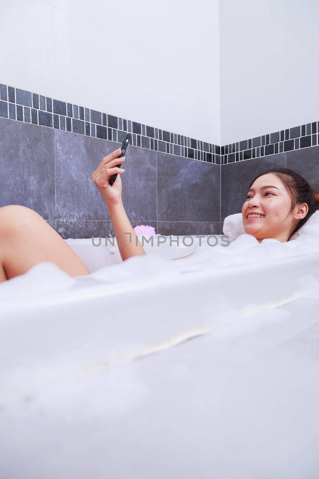 woman making selfie photo in bathtub in bathroom by geargodz