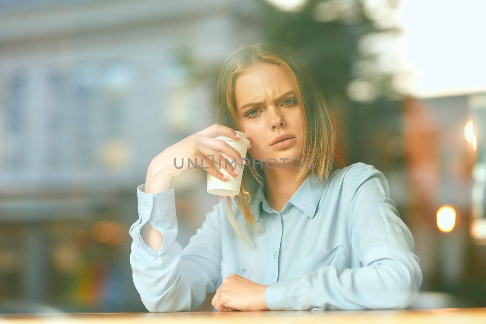 Business woman in a cafe in the summer outdoors on vacation by Vichizh