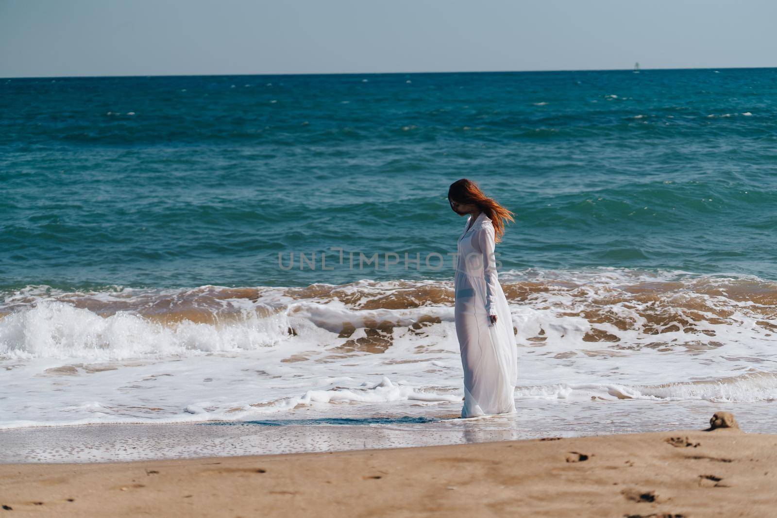 woman silhouette sandy beach waves ocean nature Lifestyle. High quality photo
